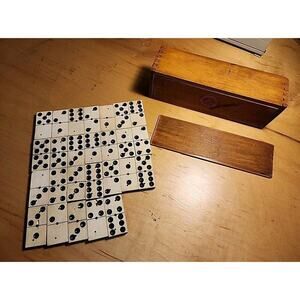 Set of antique dominoes. Comes in a wooden box with sliding lid and dove tail